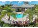 Gorgeous community pool with inviting cool water, plenty of lounge seating surrounded by palm trees at 7576 Plantation Cir, Bradenton, FL 34201