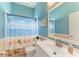 Bathroom with beach themed shower curtain and decor, and white vanity at 8136 Snowy Egret Pl, Bradenton, FL 34202