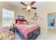 Bedroom with natural light, orange bedding, and a comfy arm chair at 8136 Snowy Egret Pl, Bradenton, FL 34202