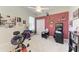 A versatile bedroom featuring a home gym, a vibrant accent wall, and ample natural light from the window at 8136 Snowy Egret Pl, Bradenton, FL 34202