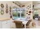 Cozy dining area features a built-in banquette, bright light, and a view of the pool at 8136 Snowy Egret Pl, Bradenton, FL 34202