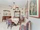 Cozy dining area with a round table, unique chairs, and decorative art displayed on the walls at 8136 Snowy Egret Pl, Bradenton, FL 34202