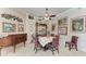 Charming dining space with a round table, whimsical chairs, and vintage circus-themed artwork at 8136 Snowy Egret Pl, Bradenton, FL 34202