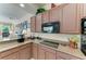 Bright eat-in kitchen with warm wood cabinets, granite counters, and modern appliances at 8136 Snowy Egret Pl, Bradenton, FL 34202