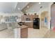 Open kitchen boasts neutral countertops and cabinets with views into the bright living room at 8136 Snowy Egret Pl, Bradenton, FL 34202