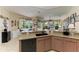 Spacious eat-in kitchen with island sink, modern dishwasher, and warm countertops at 8136 Snowy Egret Pl, Bradenton, FL 34202