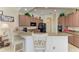 Eat-in kitchen with granite counters and wood cabinets, plus barstool seating for casual dining at 8136 Snowy Egret Pl, Bradenton, FL 34202
