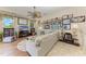 Cozy living room with plush sofa, ceiling fan, entertainment center, and lots of art at 8136 Snowy Egret Pl, Bradenton, FL 34202