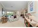 Spacious living room with floral sofas, a view of the pool, and an open layout for entertaining at 8136 Snowy Egret Pl, Bradenton, FL 34202