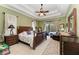 Inviting main bedroom suite with tray ceiling, outdoor access, and decorative lamps at 8136 Snowy Egret Pl, Bradenton, FL 34202