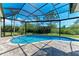 Inviting screened-in pool offers a refreshing retreat with beautiful landscaping and a serene atmosphere at 8136 Snowy Egret Pl, Bradenton, FL 34202