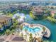 Aerial view of community pool, lake, and building at 8325 38Th Street E Cir # 107, Sarasota, FL 34243