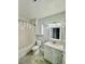 Bright bathroom with shower and tub combination, a vanity with sink, and white cabinet at 8325 38Th Street E Cir # 107, Sarasota, FL 34243