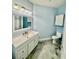 Bathroom featuring a white vanity and cabinet with unique floor at 8325 38Th Street E Cir # 107, Sarasota, FL 34243