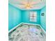 Bright bedroom with unique flooring, a ceiling fan, and a window at 8325 38Th Street E Cir # 107, Sarasota, FL 34243