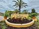 Serenata condominium residences sign surrounded by lush tropical landscaping at 8325 38Th Street E Cir # 107, Sarasota, FL 34243