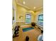 Private exercise room featuring weights, a yoga mat, and natural light at 8325 38Th Street E Cir # 107, Sarasota, FL 34243