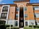 A view of the exterior of a stucco residential building with stairs to upper levels at 8325 38Th Street E Cir # 107, Sarasota, FL 34243