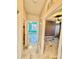 Hallway showcasing access to bedrooms with fans, windows with shutters, and stylish floors at 8325 38Th Street E Cir # 107, Sarasota, FL 34243