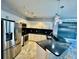 Bright kitchen features modern appliances, granite counters, and trendy lighting fixtures at 8325 38Th Street E Cir # 107, Sarasota, FL 34243