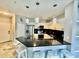 Bright kitchen features modern appliances, granite counters, island seating and trendy lighting at 8325 38Th Street E Cir # 107, Sarasota, FL 34243