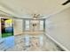 Light-filled living room with stylish floors, ceiling fan, and access to the outdoors at 8325 38Th Street E Cir # 107, Sarasota, FL 34243