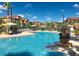 Community pool with lounge chairs and a clear blue sky at 8325 38Th Street E Cir # 107, Sarasota, FL 34243