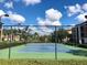 Outdoor tennis court surrounded by lush landscaping and secure fencing at 8325 38Th Street E Cir # 107, Sarasota, FL 34243