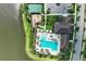 Aerial view of the clubhouse area with pool, playground, basketball court, and parking at 8936 Artisan Way, Sarasota, FL 34240