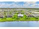 Scenic aerial view showcasing the community's homes by the lake and the neighborhood landscape at 8936 Artisan Way, Sarasota, FL 34240