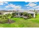 Aerial view of the backyard featuring the in-ground pool, screened enclosure, and well-manicured yard at 8936 Artisan Way, Sarasota, FL 34240