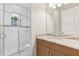 Well-lit bathroom featuring a sleek glass enclosed shower and marble countertops at 8936 Artisan Way, Sarasota, FL 34240
