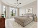 Cozy bedroom with tray ceilings, a ceiling fan, two large windows, and stylish furniture at 8936 Artisan Way, Sarasota, FL 34240