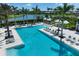 Beautiful community pool with comfortable lounge chairs and cabanas, surrounded by lush landscaping at 8936 Artisan Way, Sarasota, FL 34240