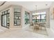 Bright dining room featuring a waterfront view, chandelier, and stylish neutral toned furniture at 8936 Artisan Way, Sarasota, FL 34240