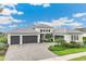 Beautiful single-Gathering home with a three-car garage and a well-manicured front yard at 8936 Artisan Way, Sarasota, FL 34240