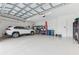 Spacious garage with epoxy flooring provides ample room for parking and storage with an overhead door at 8936 Artisan Way, Sarasota, FL 34240