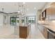 Spacious kitchen with a large island, granite countertops, and stainless steel appliances at 8936 Artisan Way, Sarasota, FL 34240