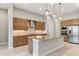 A modern island kitchen featuring stainless steel appliances and wooden cabinetry at 8936 Artisan Way, Sarasota, FL 34240