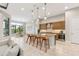Open-concept kitchen with a granite island, breakfast bar, and stainless steel appliances at 8936 Artisan Way, Sarasota, FL 34240
