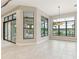 Bright and airy living room with large windows overlooking a serene outdoor space at 8936 Artisan Way, Sarasota, FL 34240