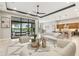 Stylishly furnished living room with tile flooring, a ceiling fan, and a view of the pool at 8936 Artisan Way, Sarasota, FL 34240