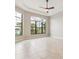 Spacious living room with a ceiling fan and two large windows overlooking the water at 8936 Artisan Way, Sarasota, FL 34240