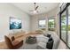 Comfortable living room with ceiling fan, neutral toned furniture, and water view at 8936 Artisan Way, Sarasota, FL 34240