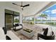 Outdoor lanai featuring an inground pool, a water view, stone pavers, and modern outdoor furniture at 8936 Artisan Way, Sarasota, FL 34240