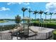 Community playground featuring slides, swings and lake view at 8936 Artisan Way, Sarasota, FL 34240
