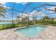 Beautiful screened-in pool features brick pavers, a water feature, and a lovely view of the water at 8936 Artisan Way, Sarasota, FL 34240