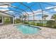 This in-ground pool features brick pavers, screen enclosure, and offers a lovely view of the lake at 8936 Artisan Way, Sarasota, FL 34240