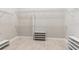 Spacious walk-in closet with ample shelving and tiled floor at 8936 Artisan Way, Sarasota, FL 34240
