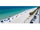 Panoramic aerial view of a sun-kissed beach, crystal-clear ocean, and adjacent parking area at 901 Gulf S Dr # 14, Bradenton Beach, FL 34217